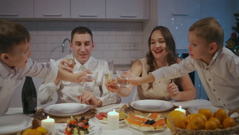Festive-family-dinner.-A-family-with-two-children-at-the-table-on-Thanksgiving.-Celebrate-the-new-year-together.-Dinner-on-Christmas-Eve.-High-quality-4k-footage